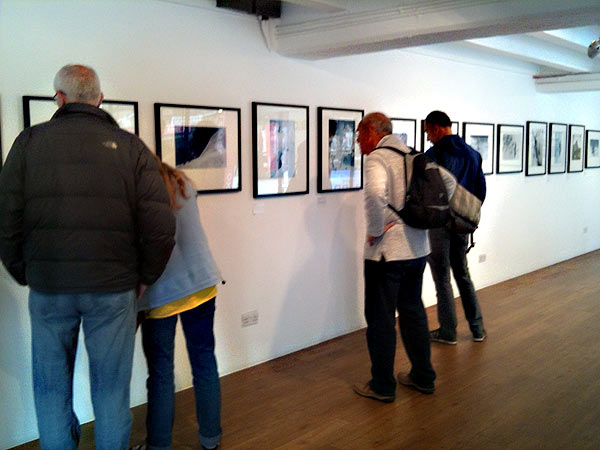 Visitors examine photographs from the 1953 Everest expedition at an exhibition in the Oxo Gallery