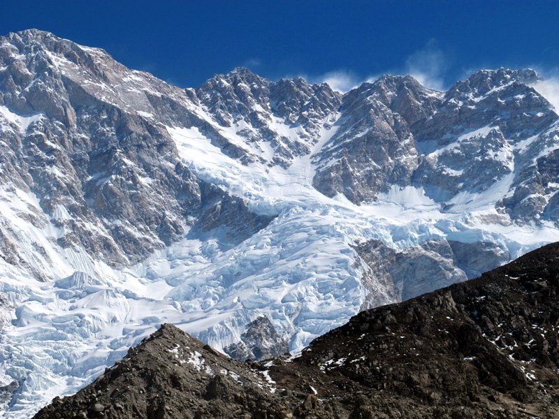 The Southwest Face of Kangchenjunga. The summit route leads up a snow slope called the Gangway to the col on the left (Photo: Anselm Murphy).