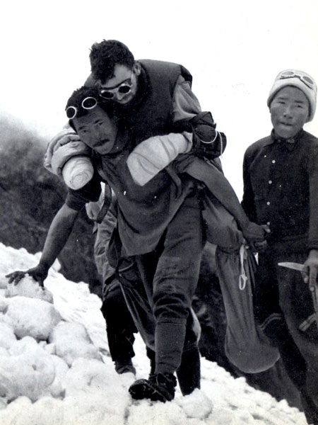 Maurice Herzog was carried back to civilisation on porter piggy back, often across precarious log bridges (Photo: Alpinismus, Munich)