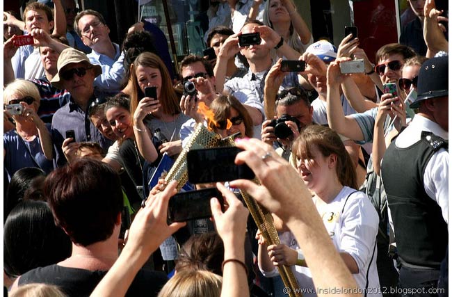 Londoners squeeze together to get a snapshot of the Olympic torch (Photo: Andy Wilkes)