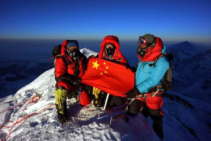 Chinese mountaineer Wang Jing with two of her Sherpa team on the summit of Everest after their helicopter assisted ascent this year (Photo: Wang Jing)